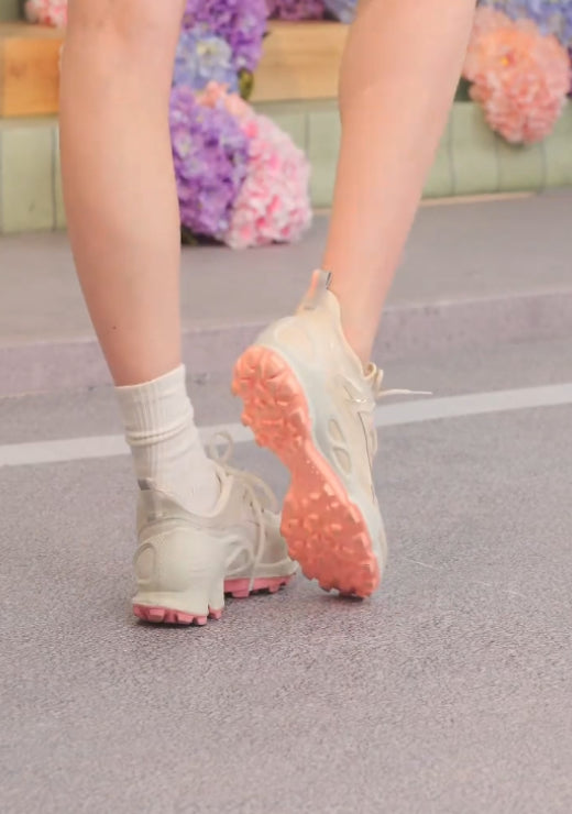 White casual shoes with pink soles