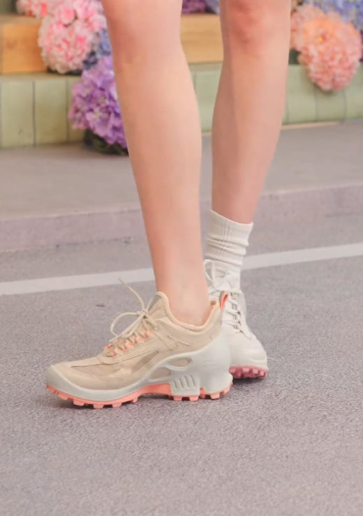 White casual shoes with pink soles