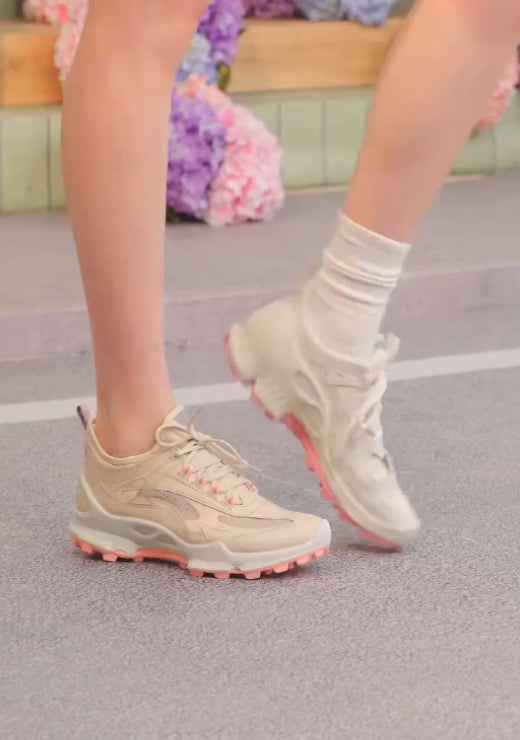 White casual shoes with pink soles